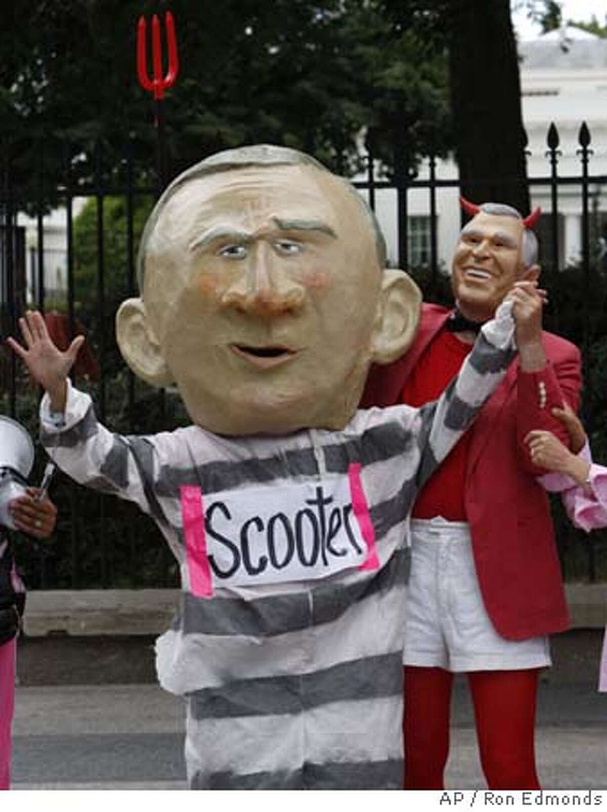 Members of the activist group Code Pink take part in a demonstration in front of the White House in Washington, Tuesday, July 3, 2007, to protest President Bush commuting of the prison sentence of I. Lewis "Scooter" Libby. (AP Photo/Ron Edmonds)