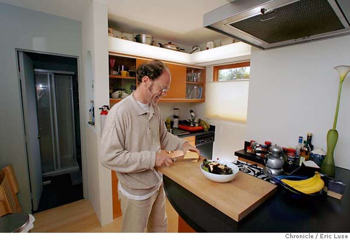 smallhousexx_076.JPG Dirk is pulling together a salad for dinner in his compact kitchen. Dirk Dieter's 210 square foot house in Pacifica. Photographer: Eric Luse / The Chronicle names (cq) from source Dirk Dieter MANDATORY CREDIT FOR PHOTOG AND SF CHRONICLE/NO SALES-MAGS OUT