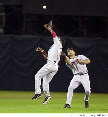 Boston Red Sox Damian Jackson (2) collides with Johnny Damon while trying  to catch a Jermaine Dye pop fly in Oakland, Ca., October 6, 2003. The Red  Sox defeated the Oakland A's