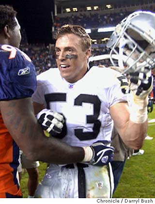 Oakland Raiders linebacker Bill Romanowski runs with the football