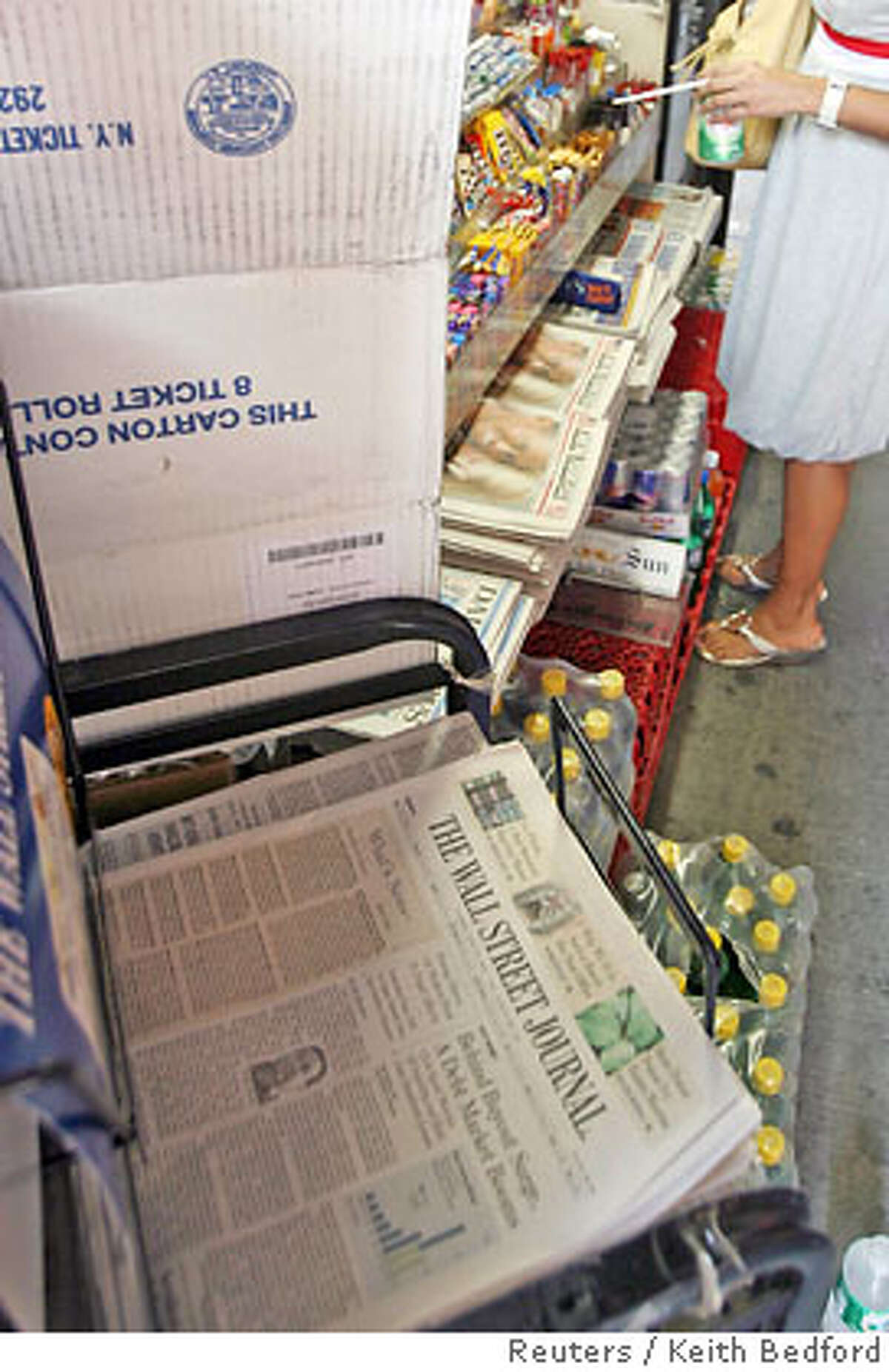 A copy of the Wall Street Journal is pictured in a newsstand in New York, June 26, 2007. Rupert Murdoch's News Corp. and Dow Jones & Co. Inc. have "basically agreed" on a structure to protect the editorial independence of Dow Jones' news operations, a source familiar with the matter said on Tuesday. News Corp. is offering $5 billion to buy Dow Jones. REUTERS/Keith Bedford (UNITED STATES)