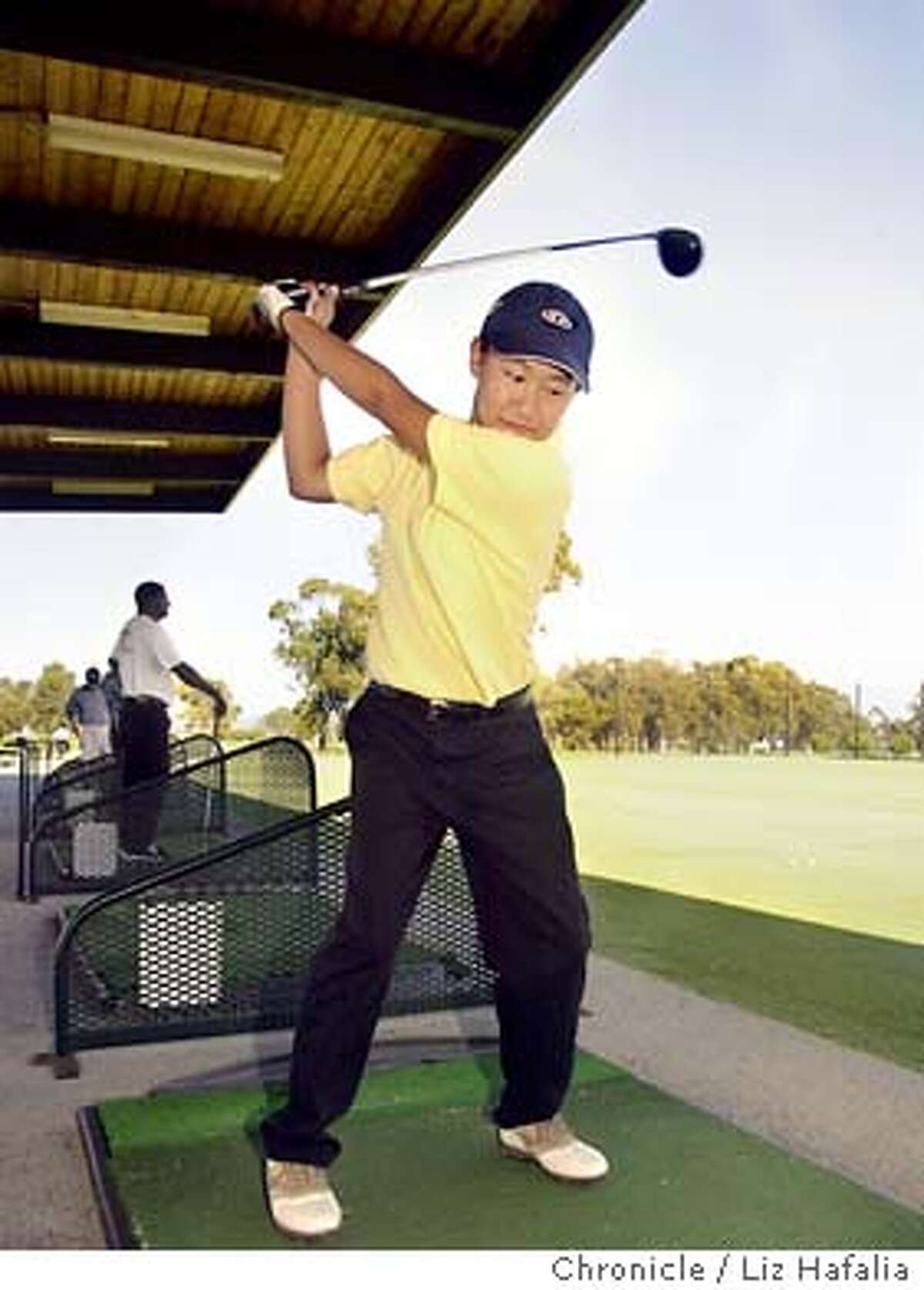 Ki-Shui Liao, 15 years old, is an outstanding young golfer who competes on the boys team of Alameda High school. She practices nearly every day and is at the driving range of Chuck Corica Golf Course. Shot on 7/3/03 in Alameda. LIZ HAFALIA / The Chronicle