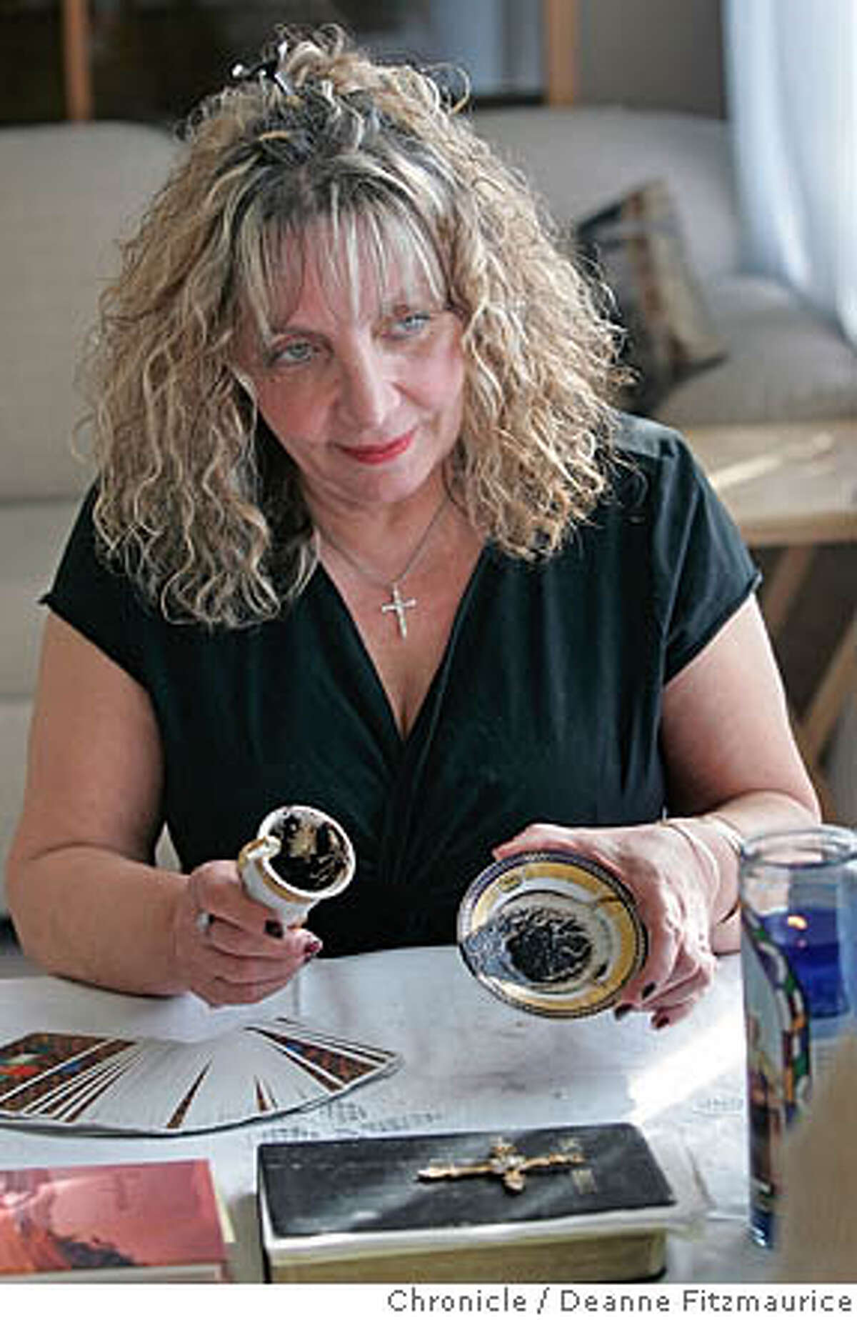 Artemis Donikian (cq) reads coffee grounds on a cup and saucer to tell fortunes in her Burlingame home. Event in Burlingame on 12/16/05. Deanne Fitzmaurice / The Chronicle
