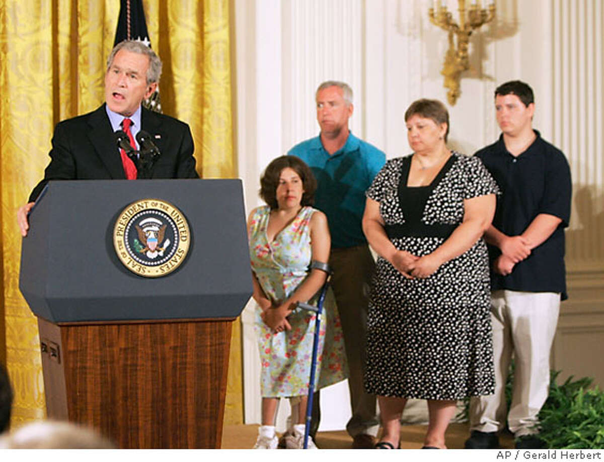 President Bush, left, accompanied by the McNamara family of Middletown, Conn., from second from left, spina bifida patient Kaitlyne McNamara, her parents Mike and Tracy McNamara, and brother Ian McNamara, right, makes remarks on stem cell research, Wednesday, June 20, 2007, in the East Room of the White House in Washington. (AP Photo/Gerald Herbert)