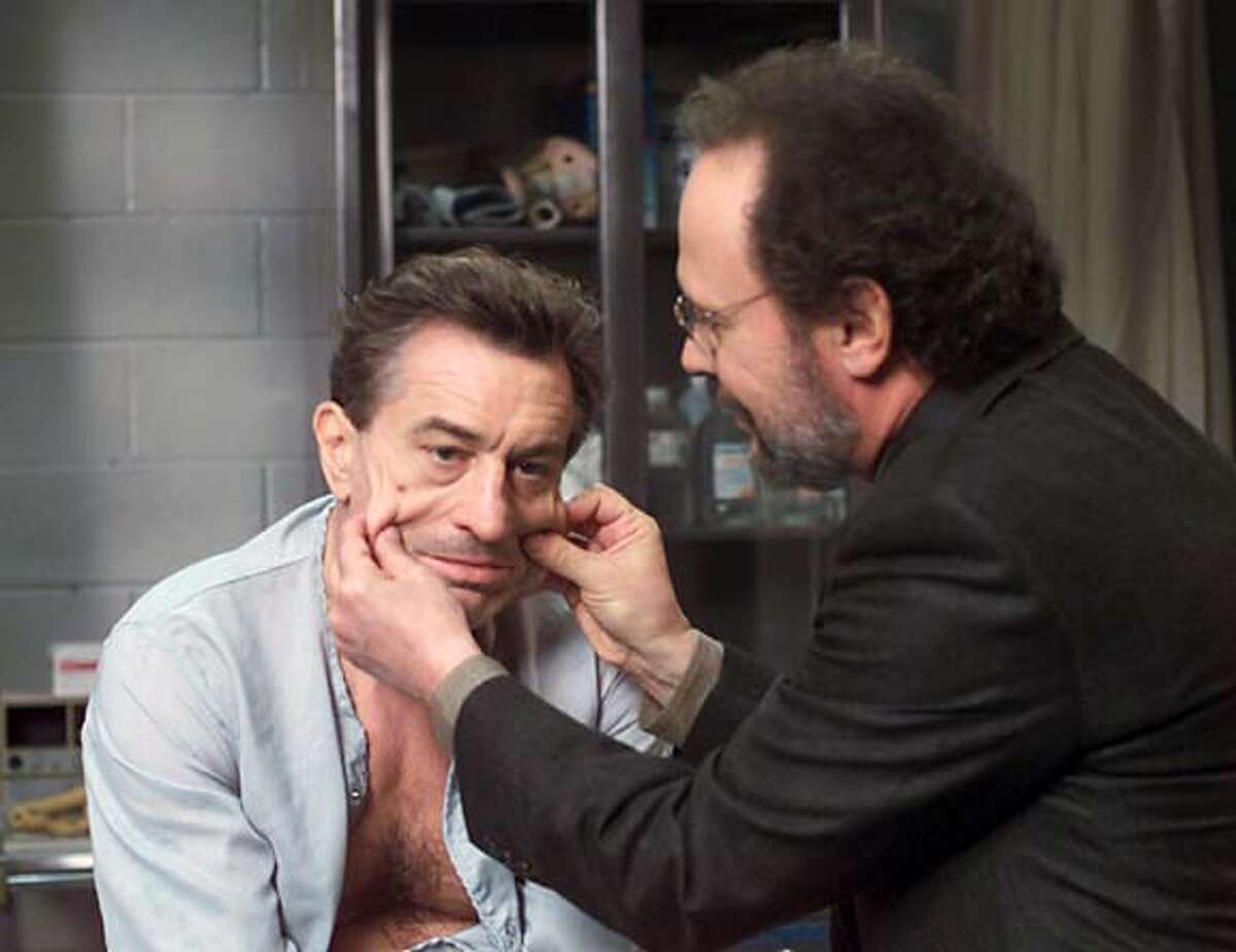 Actors Billy Crystal (R) and Robert DeNiro are pictured in this undated publicity photograph in a scene from their new comedy film " " which opens December 6, 2002 in the United States. DeNiro portrays mob boss Paul Vitti who is nearing the end of his term in prison and uses his psychiatrist played by Crystal to help him get released from prison feigning mental problems. REUTERS/Warner Bros./Handout