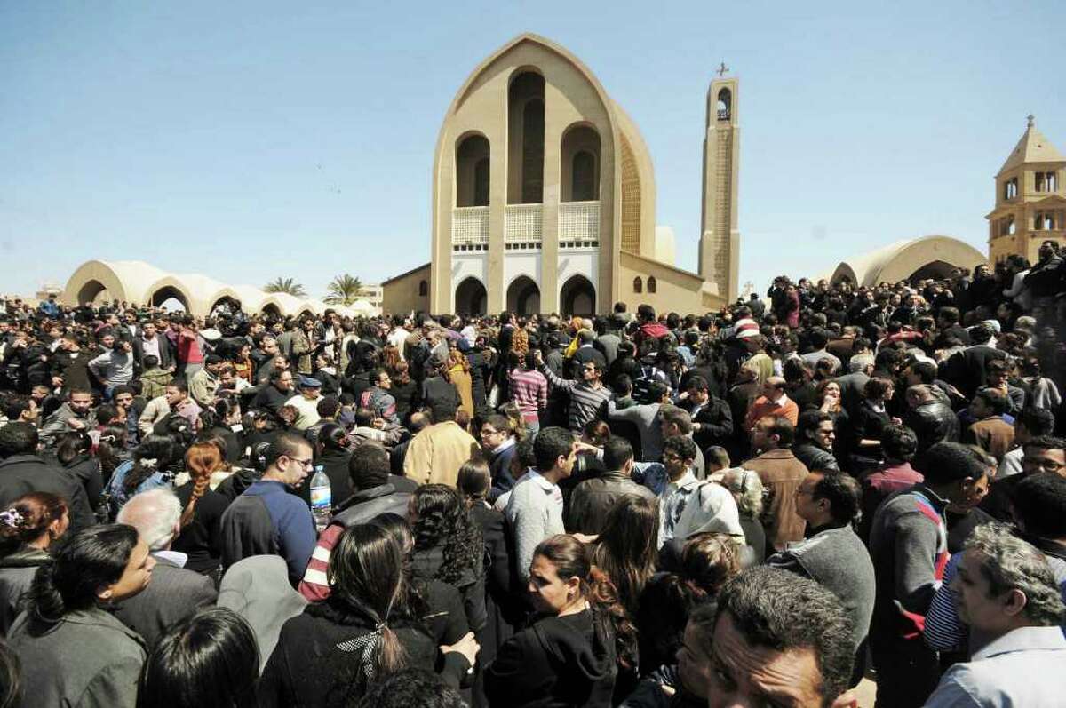 Mourners gather outside the Coptic Orthodox Church for the viewing of the body of Pope Shenouda III in Cairo, Egypt, Sunday, March 18, 2012. (AP Photo/Ahmad Hammad)