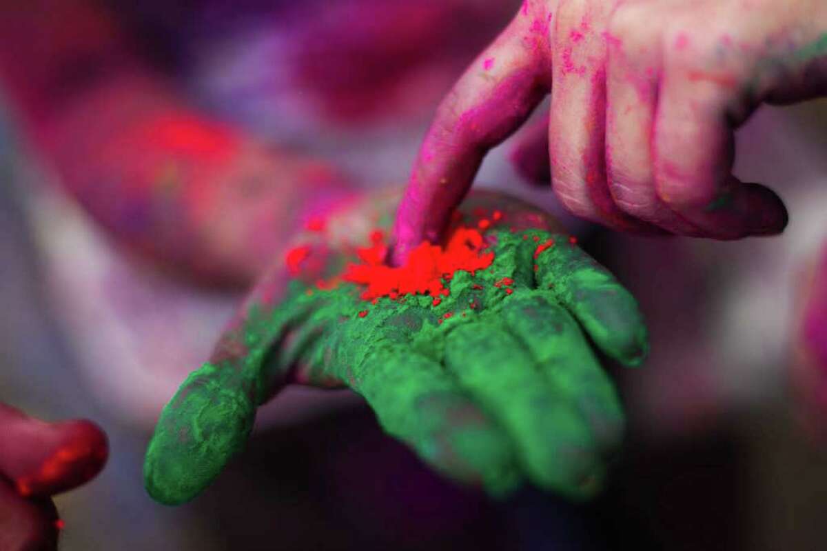 Indian devotee display coloured powder during 'Holi' at a temple in Kuala Lumpur on March 18, 2012.