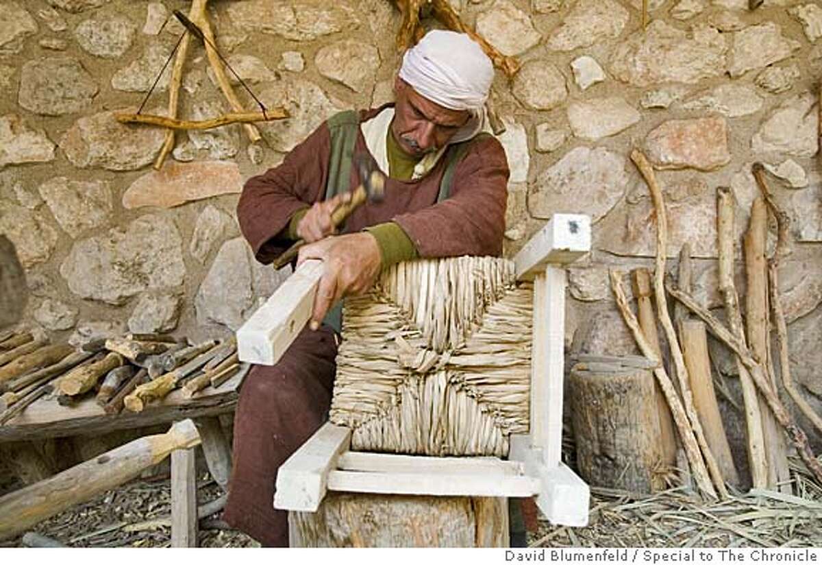 Nazareth, Israel: A "carpenter" hammers together a chair at the Nazareth Village. Photo by David Blumenfeld/Special to The Chronicle