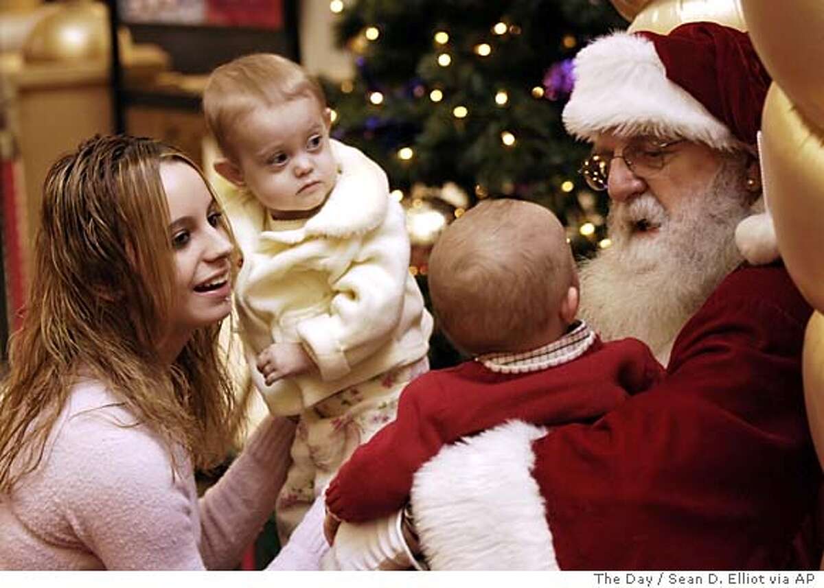 Sarah McDonald, left, places her daughter Sage, 2, onto Santa's lap as Santa Claus entertains Sage's cousin Tyler McDonald, 1, at the Crystal Mall in Waterford, Conn., Tuesday, Dec. 20, 2005. (AP Photo/The Day, Sean D. Elliot) ** MANDATORY CREDIT, MAGS OUT, , TV OUT WORLD WIDE OUT ** MANDATORY CREDIT: SEAN D. ELLIOT/THE DAY, TV OUT, MAGS OUT, WIDE WORLD OUT, , MANDATORY CREDIT: