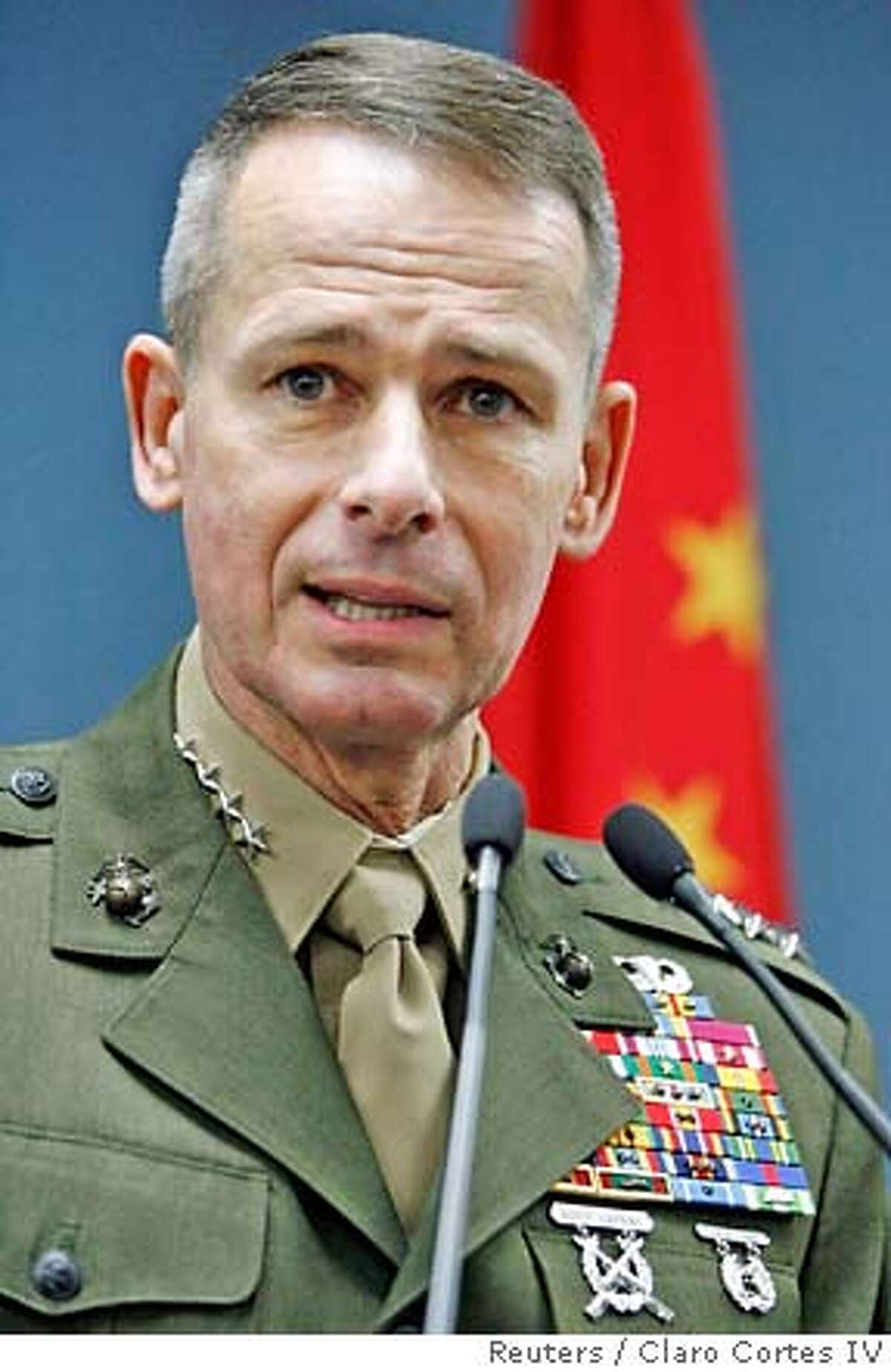 Chairman of the U.S. Joint Chiefs of Staff, Marine Gen. Peter Pace answers a question during a news conference in Beijing, in this March 23, 2007 file photo. Pace, the top U.S. military officer, will retire at the end of his term later this year and be replaced by Navy Adm. Mike Mullen, Defense Secretary Robert Gates said on June 8, 2007. REUTERS/Claro Cortes IV/Files (CHINA) 0