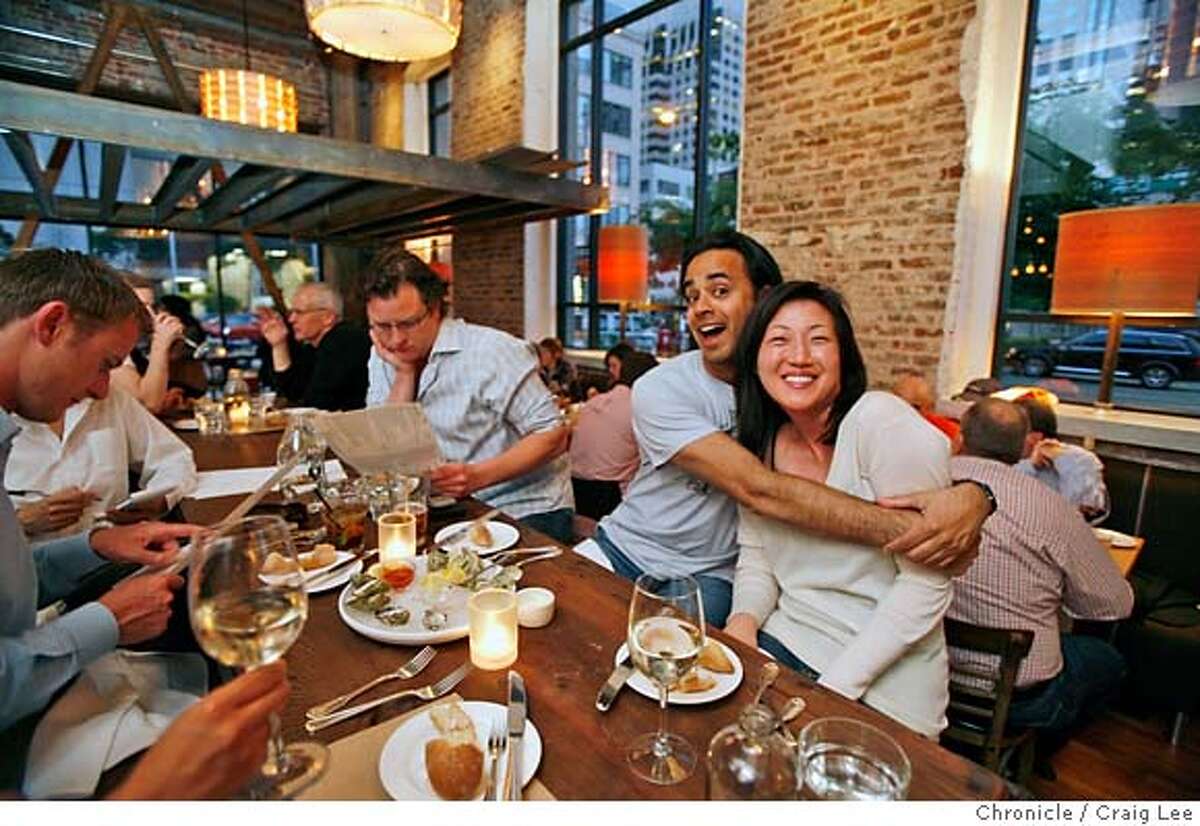 COMMUNAL06_277_cl.JPG Story on restaurants that have communal tables. This is Salt House restaurant at 545 Mission street in San Francisco. Photo of Imraan Aziz giving a hug to his new friend, Jun Chong at the communal table. They did not know each other until sitting next to each other at the communal table. The man in the glasses next to Imraan, is Robert Garrett. Event on 5/21/07 in San Francisco. photo by Craig Lee / The Chronicle MANDATORY CREDIT FOR PHOTOG AND SF CHRONICLE/NO SALES-MAGS OUT