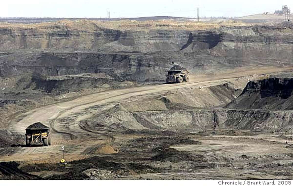 ft_mcmurray751_ward.jpg At the Chevron oilsands project north of Fort McMurray, giant earth haulers drive into the canyon created by the strip mining process. They work 24 hours a day carrying the raw dirt coated with oilsands out of the manmade canyon. The oil sands area of Alberta, Canada is perhaps the answer to Canada and America's energy needs for the next 40 years. The oil is attached to tiny grains of sand and dirt and is being mined all around the city of Fort McMurray. This has caused a "boomtown" atmosphere in the small town. Even with good salaries for workers at the oil sands, rents and home prices rival Northern California. Many of the "homeless" make over $30,000 a year, but still can't afford the high rents. The young workers go a little crazy on weekends at the local casino and bars...the famous mounties must patrol outside. This is a portrait of the oil sands and the town that is paying the price. Brant Ward 4/20/05 Ran on: 05-22-2005 Refining oil sands is so difficult and expensive because the oil must be extracted from sand and clay. But with oil prices on the rise, mining Canadas vast reserves has become profitable. Ran on: 05-22-2005 Refining oil sands is difficult and expensive because the oil must be extracted from sand and clay. But with oil prices on the rise, mining Canadas vast reserves has become profitable. Ran on: 05-22-2005
