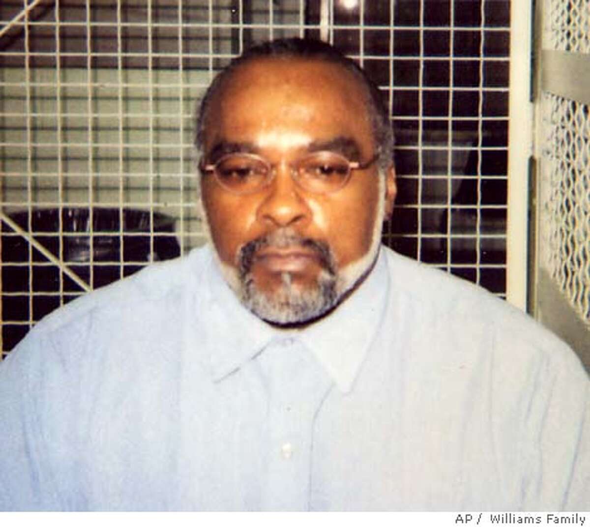 ** FILE ** In this undated photo provided by the family of Stanley Williams, Stanley "Tookie" Williams poses for a photo in the visiting area of San Quentin State Prison in California. Prosecutors asked the California Supreme Court on Sunday, Dec. 11, 2005 to reject former gang leader and convicted killer Williams' request to block his execution, set for early Tuesday. (AP Photo/Courtesy of Williams Family, File) Ran on: 12-12-2005 Ran on: 12-12-2005
