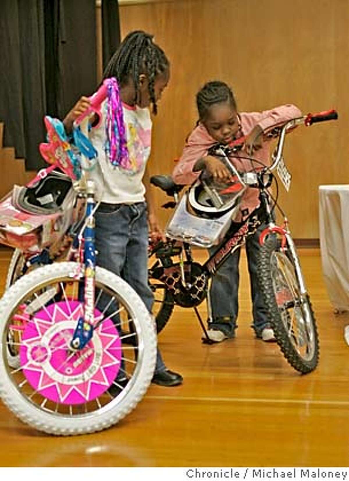 MALCOLMX_064_MJM.jpg Second graders Alexandria Wells (left) and Lonell James check out their new bikes. Malcolm X Academy in Hunters Point has a controversial, yet increasingly popular practice of offering kids big rewards for doing what's expected of them: showing up for school every day, getting decent grades, etc. Malcolm X this morning raffled off fancy bicycles to 4 lucky kids who showed up for school every day for one month. Event in San Francisco, CA Photo by Michael Maloney / The Chronicle MANDATORY CREDIT FOR PHOTOG AND SF CHRONICLE/ -MAGS OUT