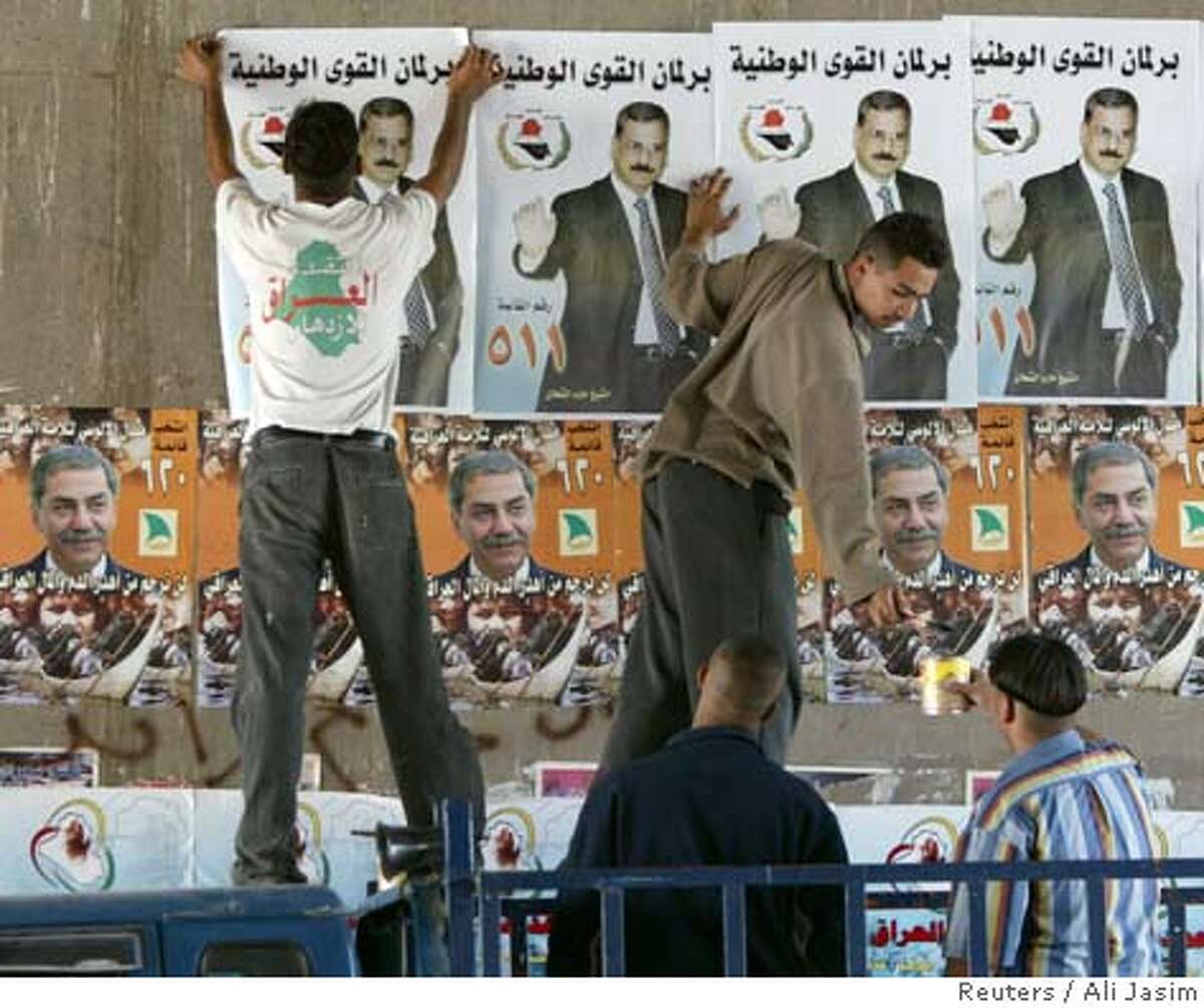 Iraqis hang election posters in central Baghdad, December 7, 2005. Iraqi officials and their American allies are pinning their hopes on December 15 elections for the first post-war, full-term government to defuse a Sunni Arab insurgency that has killed thousands of security forces and civilians. REUTERS/Ali Jasim Ran on: 12-11-2005 Election posters advertise Thursdays vote in Iraq, which has fueled Sunni Arab concern that a post-election pullout by U.S. troops could open the door to an all-out civil war.