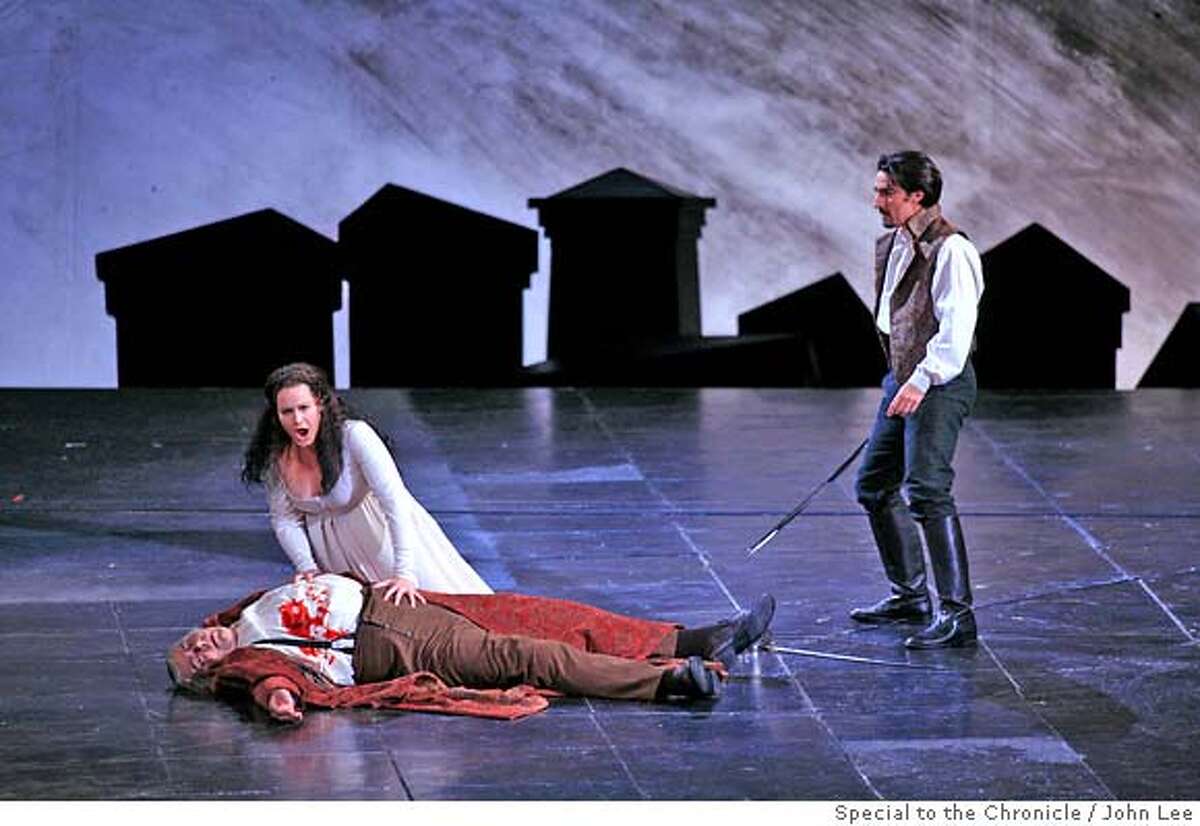 OPERA_05_02_JOHNLEE.JPG Donna Anna, left, played by Elza van den Heever (cq), mourns over the death of her father, the Commendatore, played by Kristinn Sigmundsson (cq), during the first act of Saturday night's perfomance of the San Francisco Opera's "Don Giovanni." Donna Ottavio, played by Charles Castronovo (cq), at right. By JOHN LEE/SPECIAL TO THE CHRONICLE