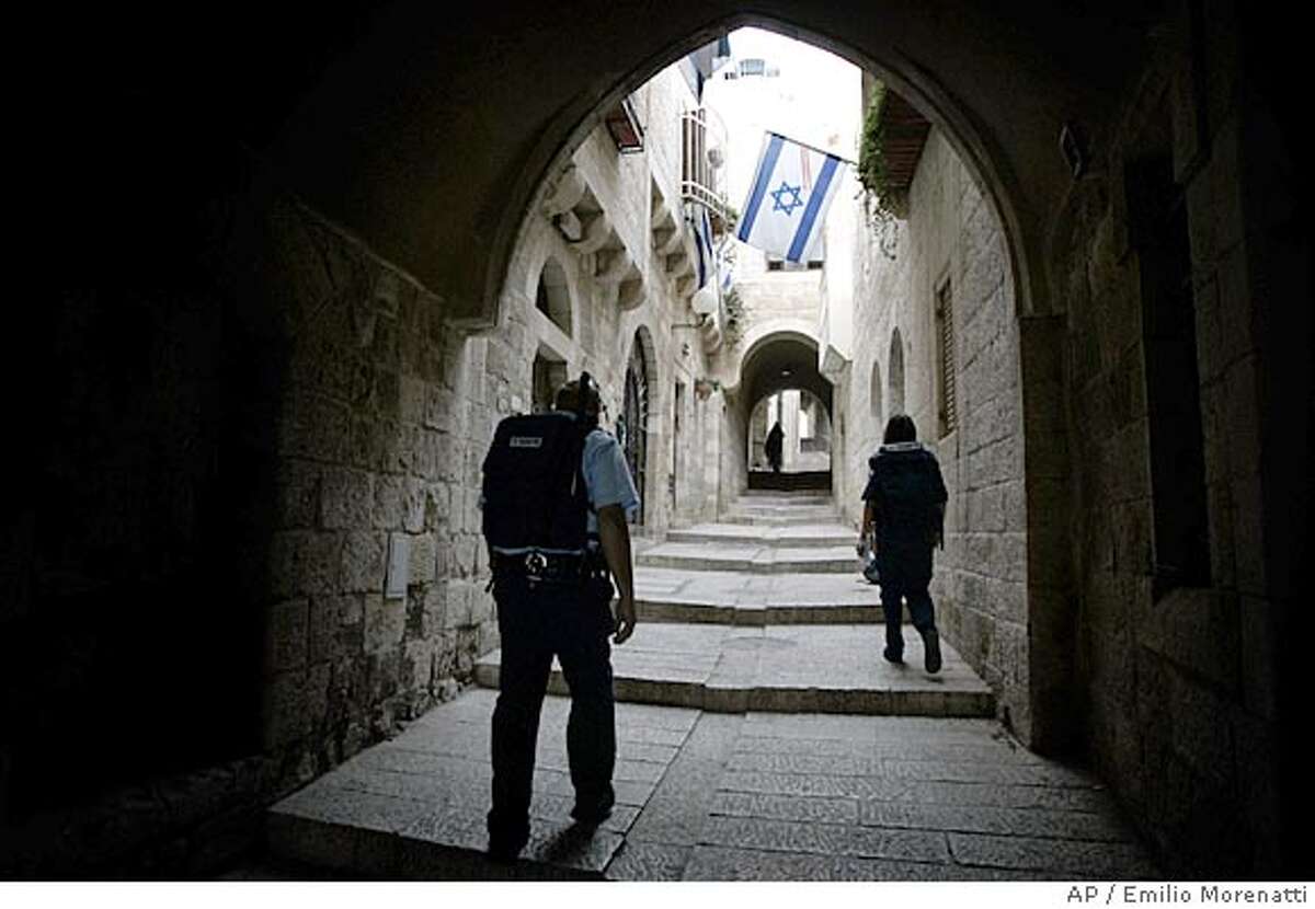 ** ADVANCE FOR SUNDAY, JUNE 3 ** Israeli police officer patrols the Jewish Quarter in Jerusalem's Old City, May 1, 2007. Four decades after an underdog Israeli military campaign that captured the world's imagination, the people of Israel, the Middle East and the world are are still struggling to come to terms with it. The war tripled Israel's size and probably prevented its annihilation. But with victory came burdens, hatreds and many, many deaths for Israelis and the Palestinians in their newly-expanded territory.(AP Photo/Emilio Morenatti)