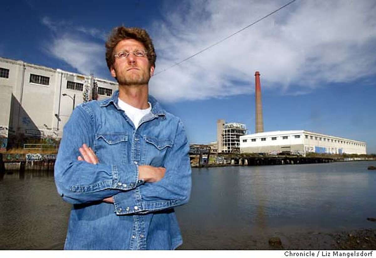 46FB0010.JPG Event on 9/10/03 in San Francisco. John Borg, a resident and business man in dogpatch, who has been leading the neighborhood opposition. This is a picture at Islais Creek(, which runs near the power plant (with the smoke stack...not the white building) in the background. LIZ MANGELSDORF / The Chronicle