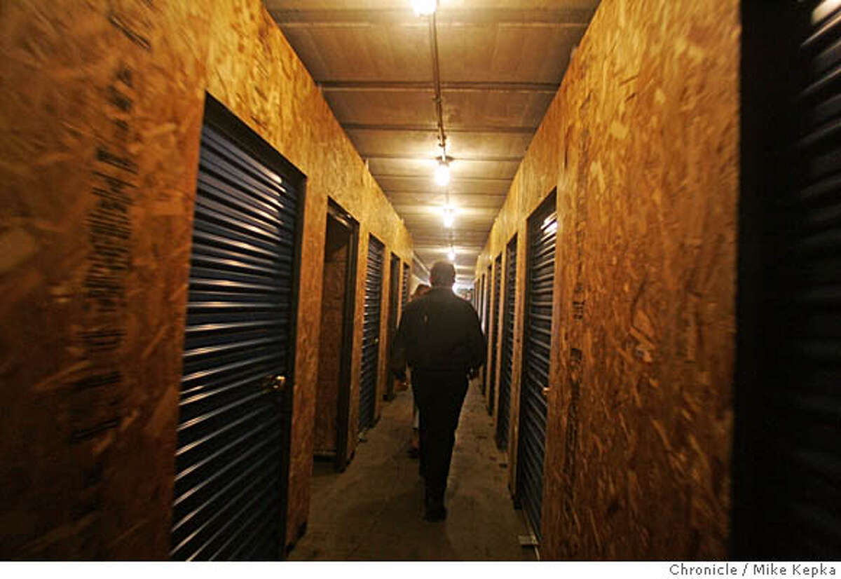 Christo Kasaris from the Presidio Wine Bunkers, walks down a hallway ready for wine storage inside on the bunkers at The Pesidio. The Presidio Trust has found that the weapons bunkers on the Presidio are perfect for storing wine. Wine storage units, big and small, are being rented out to private collectors and restaurants looking for a safe place to store their pressure bottles. San Francisco on date}. Mike Kepka / The Chronicle
