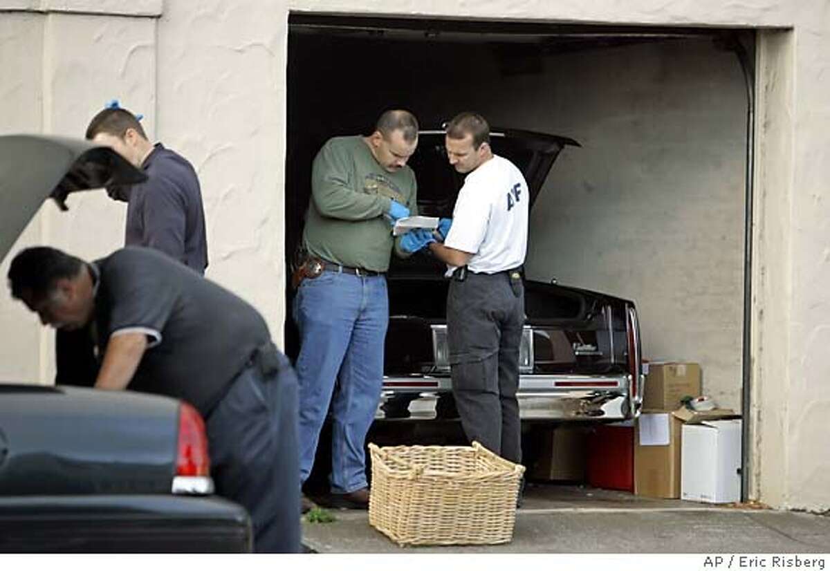 **FILE** In this file photo federal agents along with police from Vallejo and Oakland, Calif., police search a garage at the home of Mark C. Anderson, owner of Sausalito Cellars in Sausalito, Calif., on Oct. 19, 2005. Federal prosecutors on Monday, March 19, 2007, announced a 19-count indictment against Anderson for starting a 2005 blaze that destroyed a warehouse and six million bottles of wine on Mare Island, a former Naval base in Vallejo, Calif., about 30 miles northeast of San Francisco. (AP Photo/Eric Risberg) OCT. 19, 2005 FILE PHOTO