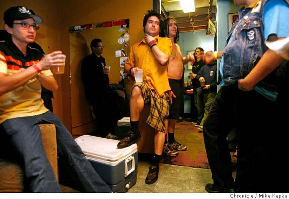 � fatmike00135_mk.JPG Backstage, Fat Mike drinks among friends before a show at Slim's in San Francisco. Mike "Fat Mike" Burkett, of San Francisco, has been leading the punk band NOFX for the last 23 years. He helped lead a political movement in punk rock music during the 2004 presidential election and now says he is hanging up his short political career to focus more on music. 2/1/07. Mike Kepka / The Chronicle Mike Burkett (cq) the source i MANDATORY CREDIT FOR PHOTOG AND SF CHRONICLE/NO SALES-MAGS OUT