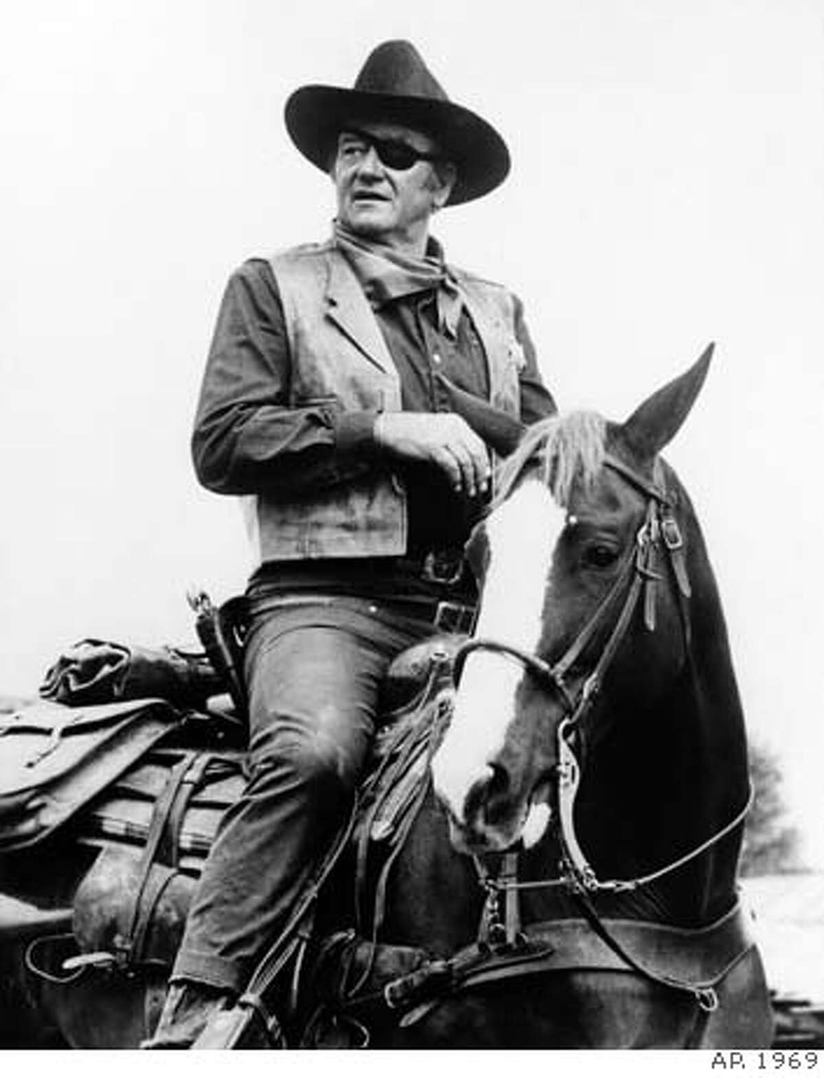 **FILE**John Wayne appears in a scene from "True Grit," a Hal Wallis production, directed by Henry Hathaway. Wayne won his best-actor Oscar for his role in the 1969 movie. Wayne, born Marion Robert Morrison, would have turned 100 on Saturday, May 26, 2007. He died at the age of 72 of stomach cancer in June of 1979 after a career that spanned more than 170 films. (AP Photo)