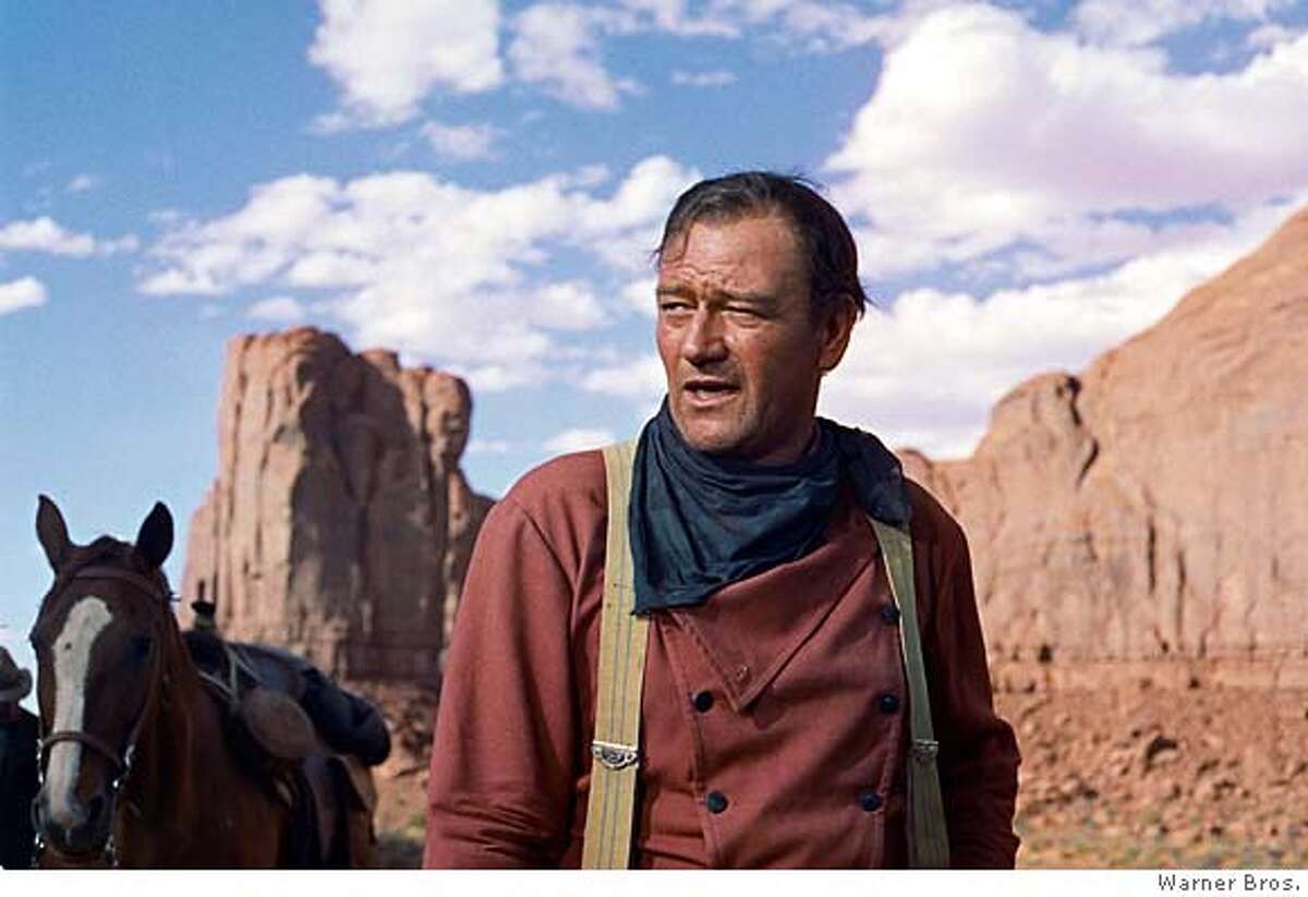 **FILE**In this photo released by Warner Bros., actor John Wayne plays Ethan Edwards in the 1956 film "The Searchers." Director John Ford and frequent leading man Wayne forged one of Hollywood's most enduring partnerships. Wayne, born Marion Robert Morrison, would have turned 100 on Saturday, May 26, 2007. He died at the age of 72 of stomach cancer in June of 1979 after a career that spanned more than 170 films (AP Photo/Warner Bros.) NO SALES, PHOTO PROVIDED BY WARNER BROS.