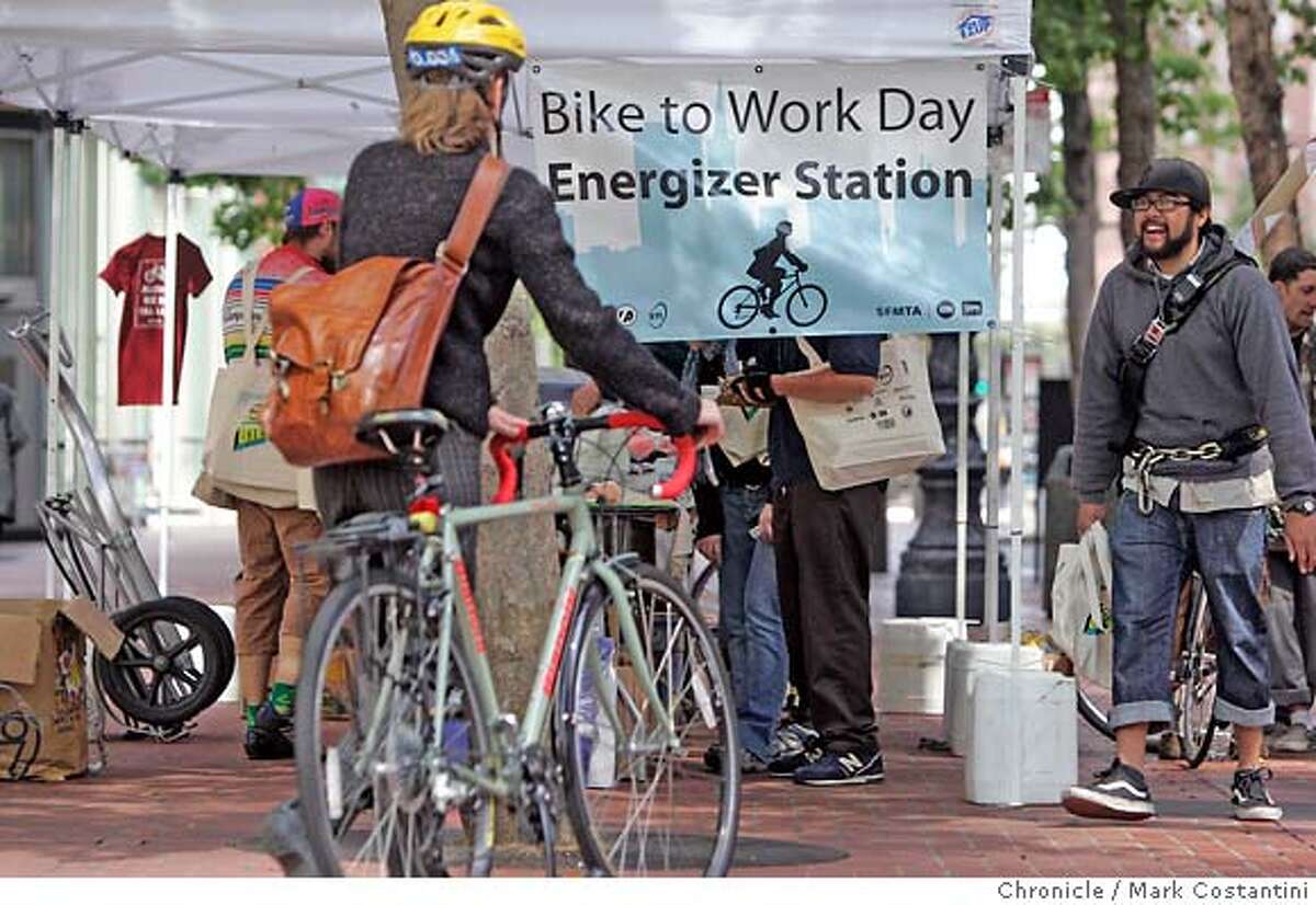People ride bikes in S.F. and stop at a booth dedicated to bike-to-work day at Bettery and Market Streets. PHOTO: Mark Costantini / The Chronicle