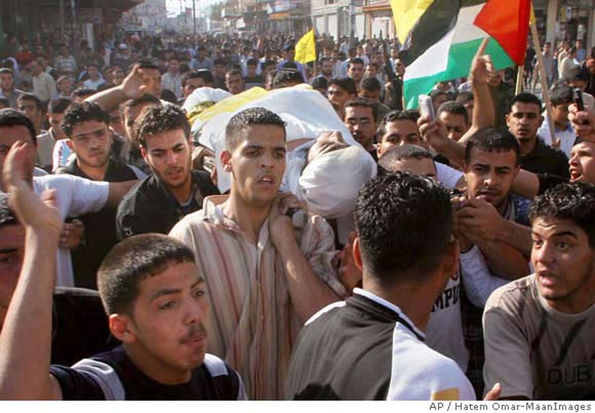 Palestinian mourners carry the body of a security force officer loyal to the Fatah Movement killed during an attack by Hamas militants, during his funeral in Gaza City,Tuesday, May 15, 2007. Hamas gunmen on Tuesday ambushed rival Fatah forces near a key crossing along the Israeli border, killing eight people in the deadliest battle yet in three days of factional fighting. The incident briefly drew Israeli gunfire, threatening to drag Israel into the conflict. (AP Photo/Hatem Omar-MaanImages)