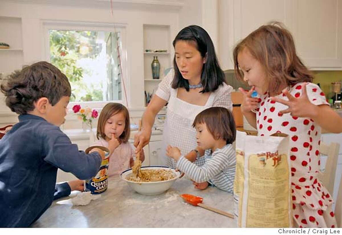 MOMS09_386_cl.JPG Story for Food mother's day story. Photo of Joohee Muromcew, author of "The Baby Bistro Cookbook," with her children, making Oatmeal Cranberry Cookies. Left-right: Alexei (age 6), Natasha, Joohee, Mary, and Nikita. The three little girls are 3 years-old triplets. Event on 4/30/07 in Ross. photo by Craig Lee / The Chronicle MANDATORY CREDIT FOR PHOTOG AND SF CHRONICLE/NO SALES-MAGS OUT