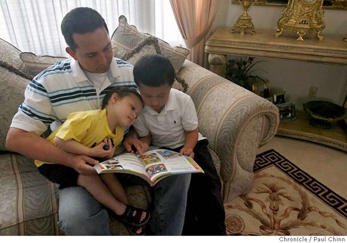 Christopher Freking reads a story with his two boys Collin, 3, (left) and Christopher, 6, at their home in Hercules, Calif. on Friday, May 4, 2007. Freking is about to lose his job as a technician at the VA Hospital in San Francisco for failing to register for selective service 16 years ago. PAUL CHINN/The Chronicle **Christopher Freking, Collin, Christopher MANDATORY CREDIT FOR PHOTOGRAPHER AND S.F. CHRONICLE/NO SALES - MAGS OUT