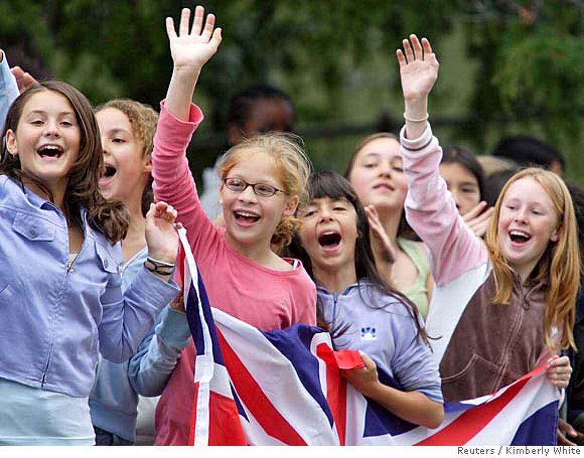 Children yell out as Britain's Prince Charles and his wife Camilla, Duchess of Cornwall, leave the Martin Luther King Middle School in Berkeley, California November 7, 2005. The royal couple is on an 8-day tour to the United States for the first time since their marriage. REUTERS/Kimberly White 0