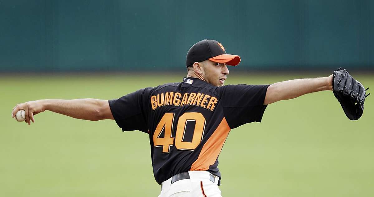 San Francisco Giants starting pitcher Madison Bumgarner throws to the San Diego Padres during the second inning of a spring training baseball game, Sunday, March 18, 2012, in Scottsdale, Ariz. (AP Photo/Marcio Jose Sanchez)
