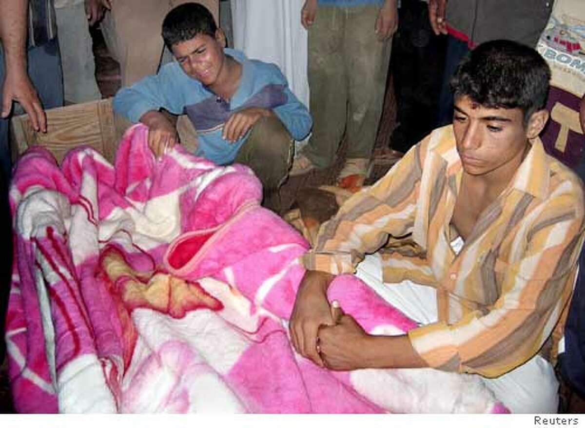 Iraqis mourn the death of a relative after a U.S. air strike on the western Iraqi city of Ramadi, October 17, 2005. U.S. fighter jets and attack helicopters killed about 70 militants around the western Iraqi city of Ramadi, the military said on Monday after a landmark vote that appears to have ratified a new constitution. A U.S. military statement said the Ramadi battle occurred on Sunday and involved U.S. jets, helicopters and ground troops. It said at least 20 militants were killed when an F-15 aircraft bombed a group of men burying a roadside bomb -- one of the deadliest weapons in the insurgent arsenal. Another 50 insurgents were killed in a series of separate strikes, the statement added, saying military commanders had no indications of any U.S. or civilian casualties in the operation. Bassem al-Dulaimi, a doctor, told Reuters on Sunday that his hospital in Ramadi had received 25 dead and eight wounded following the air strikes; it was unclear if any were civilians. REUTERS/Stringer