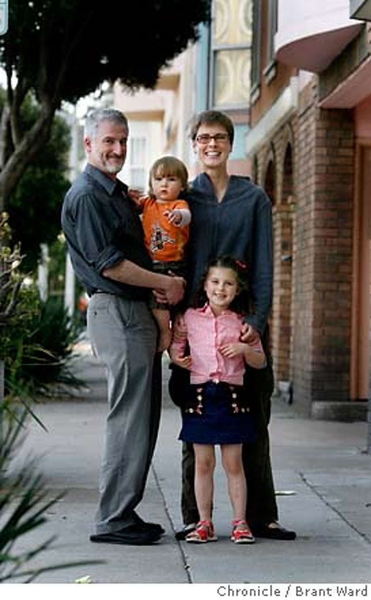 .JPG Outside their Mission district flat, l-r Jeff Goldberg, Milo (1 year) mother Gillian Gillett and daughter Lucy (5 years) in the city they love. San Francisco's middle class can't afford to buy a home in the city of San Francisco. Gillian Gillett andJeff Goldberg and their two children Lucy and Milo are stuck renting because there are no affordable homes for them to buy...for now they rent in the Mission District. {Brant Ward/San Francisco Chronicle}4/2/07