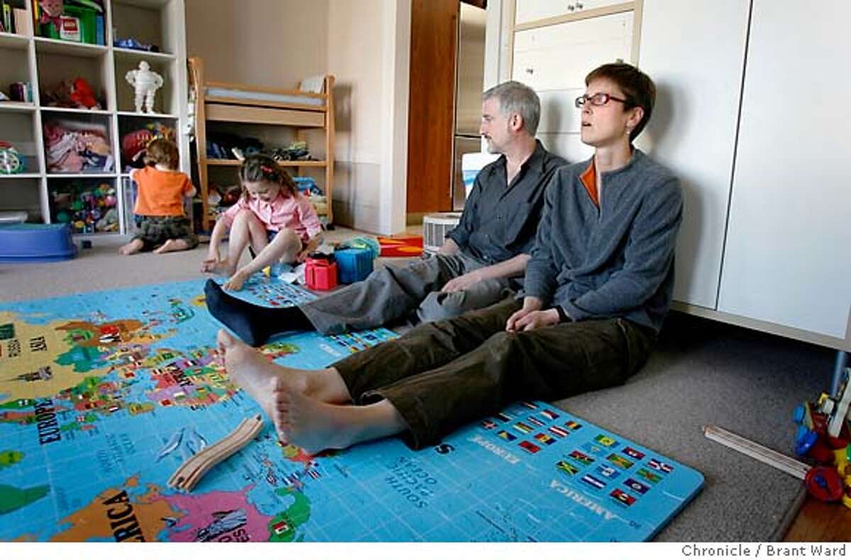 .JPG Jeff Goldberg and his wife Gillian Gillett ponder a move away from San Francisco as they sit on a huge map of the world...their children, Milo in orange and Lucy play in the family room of their flat. San Francisco's middle class can't afford to buy a home in the city of San Francisco. Gillian Gillett andJeff Goldberg and their two children Lucy and Milo are stuck renting because there are no affordable homes for them to buy...for now they rent in the Mission District. {Brant Ward/San Francisco Chronicle}4/2/07