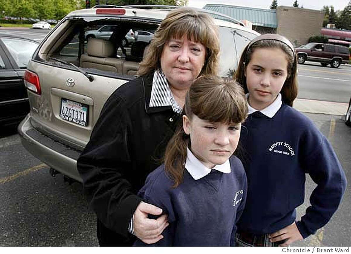 criticalmass027.JPG L-R Mother Susan Ferrando, daughter Shannon and daughter Lauren, 13, next to their van which had the back window broken. Susan Ferrando and her two daughters were in San Francisco to celebrate daughter Shannon's 11th birthday when they were attacked by members of the monthly Critical Mass bicycle ride. They are photographed at a Peninsula autobody shop where work is being done on their van. {Brant Ward/San Francisco Chronicle}4/4/07