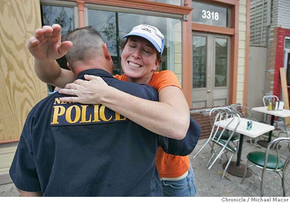 Restaurant owner, Kappa Horn hugs New Orleans PD officer Ron Dassel on her first return to the Uptown neighborhood where she runs, "Slim Goodies". Her place is a regular stop for many New Orleans Police Officers. The aftermath of Hurricane Katrina that ravaged New Orleans, Louisiana. 9/17/05 New Orleans , La Michael Macor / San Francisco Chronicle