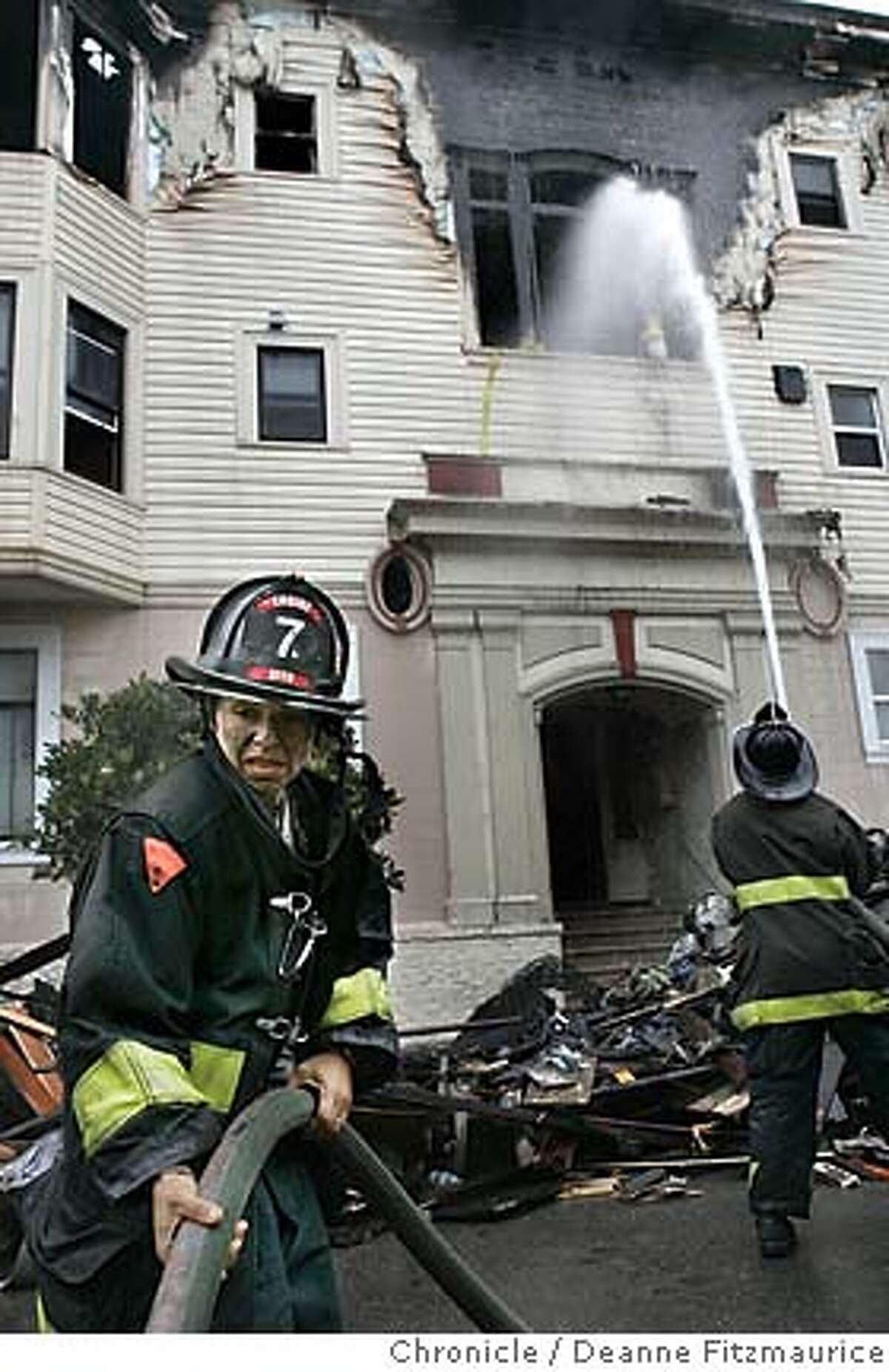 Firefighter Sadie Magaly helps with the hose. Firefighters are on the scene after an early morning fire on Capp Street in the Mission District. Deanne Fitzmaurice / San Francisco Chronicle