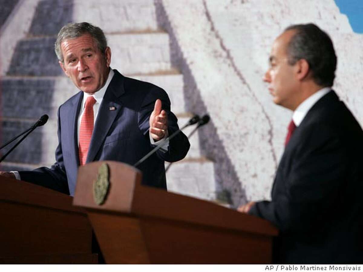 U.S. President George W. Bush, left, gestures during his news conference with Mexican President Felipe Calderon, right, Wednesday, March 14,2007, in Merida, Mexico. (AP Photo/Pablo Martinez Monsivais)