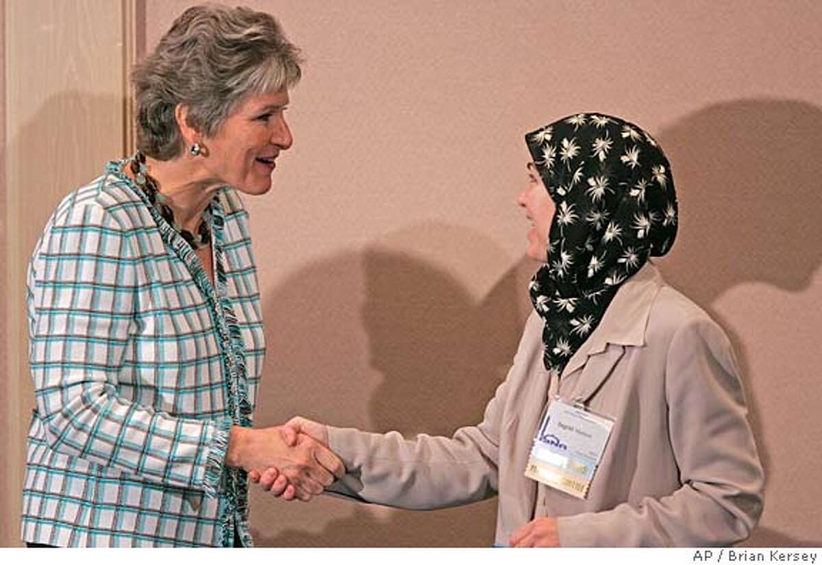 Karen Hughes, newly appointed Under Secretary of State for Public Diplomacy, left, shakes hands with ISNA vice president Ingrid Mattson during a news conference prior to the inaugural session of the Islamic Society of North America's annual convention, Friday, Sept. 2, 2005, in Rosemont, Ill. Hughes was appointed with the task of improving the image of the U.S. in Muslim countries. (AP Photo/Brian Kersey)
