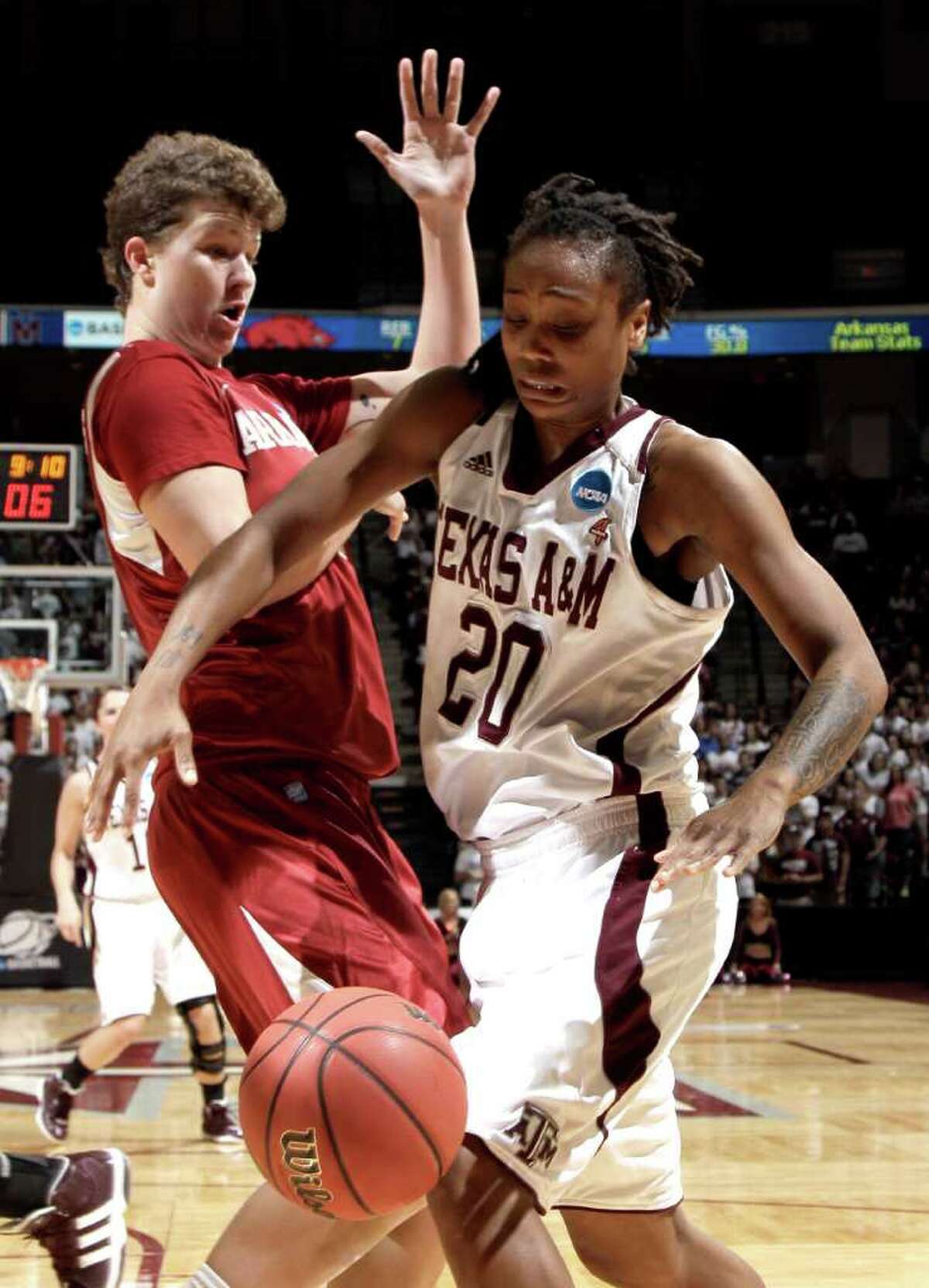 Arkansas' Sarah Watkins, left, knocks the ball loose from Texas A&M's Tyra White (20) during the first half of an NCAA tournament second-round women's college basketball game Monday, March 19, 2012, in College Station, Texas. (AP Photo/David J. Phillip