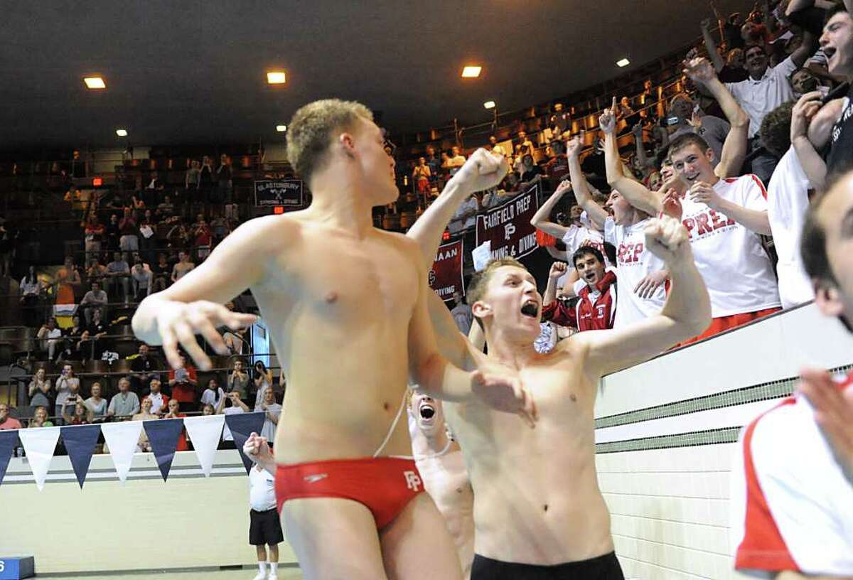 Connor Davis of Fairfield Prep, center, reacts with teammates after Prep won the Boys CIAC State Open Swimming championships at Yale University in New Haven, Conn., Saturday, March 17, 2012.