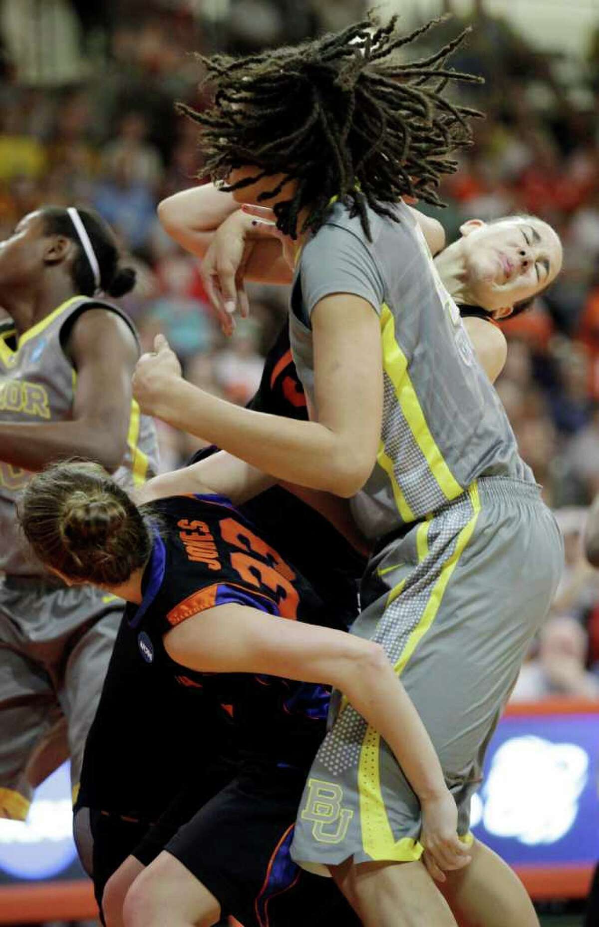 Baylor's Brittney Griner, middle, battles the lane with Florida's Jordan Jones (33) and Azania Stewart, right, during the first half of a second-round NCAA women's college basketball tournament game, Tuesday, March 20, 2012, in Bowling Green, Ohio. (AP Photo/J.D. Pooley)