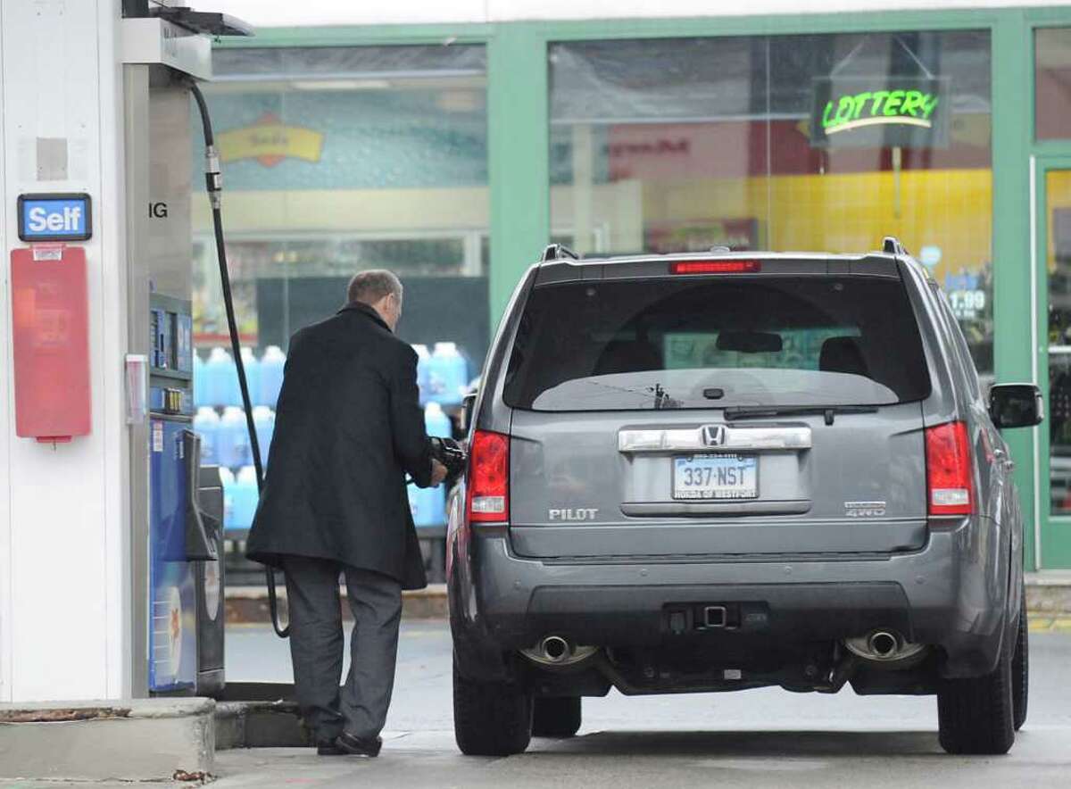 A customer pumps gas at the Mobil station on the corner of East Putnam Avenue and Sheep Hill Road March 1, 2012.