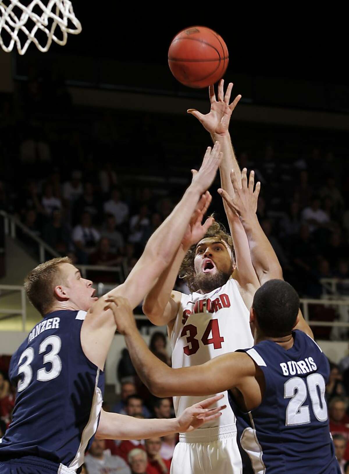 Stanford forward Andrew Zimmermann (34) scores in front of Nevada forward Kevin Panzer (33) and guard Jordan Burris (20) in the first half of a college basketball game in the NIT quarterfinals, Wednesday, March 21, 2012, in Stanford, Calif.