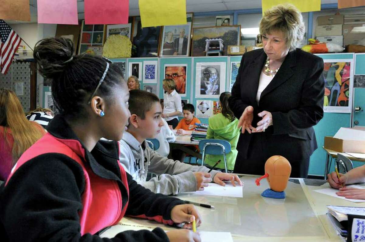 New Milford School's Superintendent JeanAnn Paddyfote, speaks with Octavia Brooks, left, and Steven Santos, both 13, students in teacher Trudy Cox's eighth-grade art class at Schaghticoke Middle School in New Milford Monday, March 19, 2012.