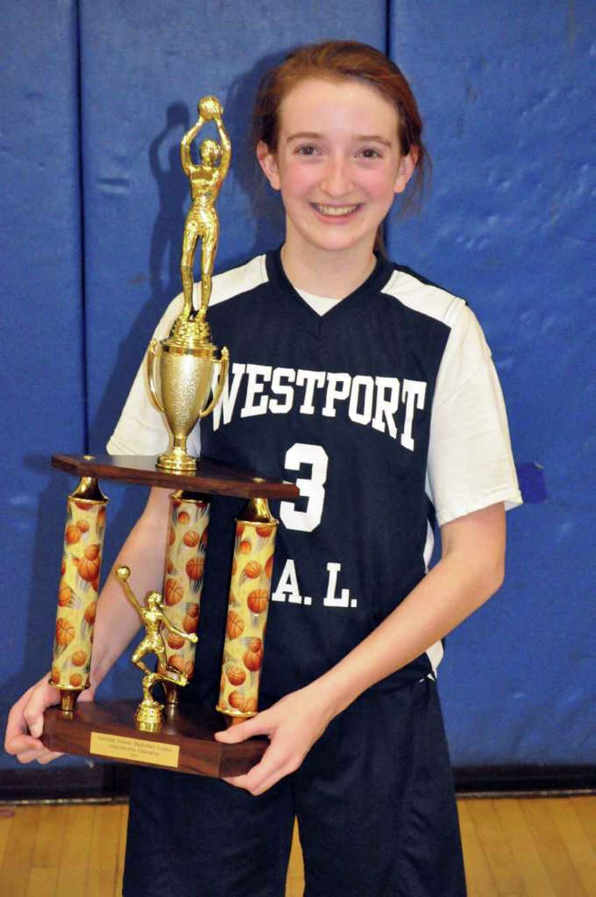 Westport PAL seventh grader Claire Meehan holds her basketball trophy after winning the Fairfield County Basketball League one-on-one championship.