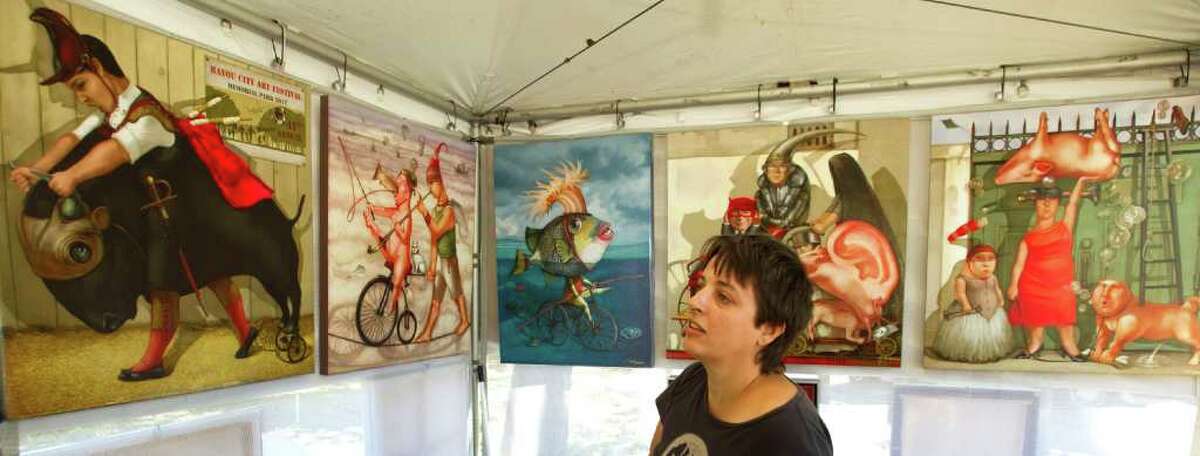 Tanya Doskova, the featured artist at Bayou City Art Festival, sets up her booth at Memorial Park Thursday, March 22, 2012, in Houston. The 41st annual outdoor event, features 300 artists and runs from Friday to Sunday.