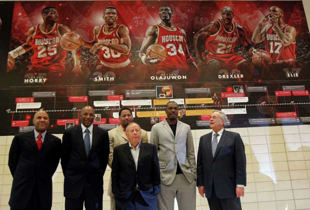Former Houston Rockets players Mario Ellie left, Clyde Drexler, Robert Horry, Rockets owner Les Alexander, Hakeem Olajuwon and former General Manager Caroll Dawson after the unveiling of a mural of the Houston Rockets team of the 1990s.